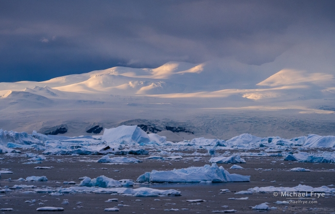 Icebergs and sunlit mountains, Antarctica