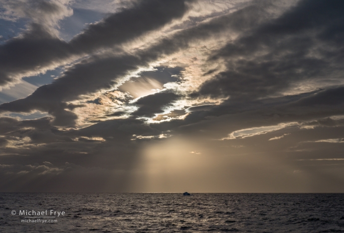 Clouds, sunbeams, and iceberg, Bransfield Straight, Antarctica