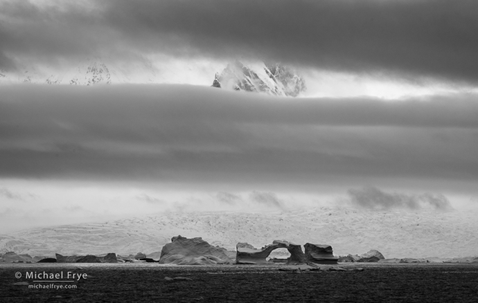 Mountains, clouds, and ice arch, Antarctica